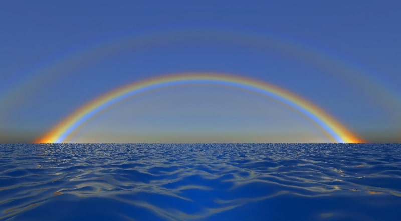 Rainbow over sea.